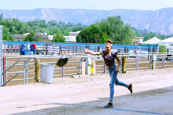 girl tossing a cast iron skillet